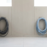 Should a separate hose be used for flushing black tanks? - Image of a technician wearing protective gear while inspecting a water storage tank in Dubai.